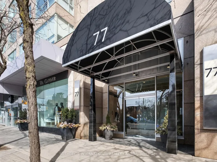 Building entrance with a black 77 awning, glass lobby frontage and sidewalk planters at 77 Avenue Road, Toronto, Ontario