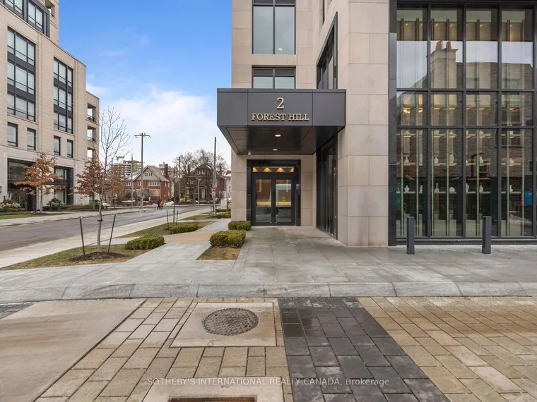 Limestone and glass mid-rise condominium entrance with a 2 Forest Hill sign above the doors at 2 Forest Hill Road, Toronto, Ontario